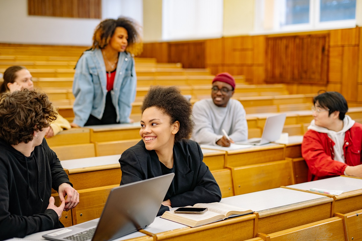 Five multi-racial college students in a college classroom